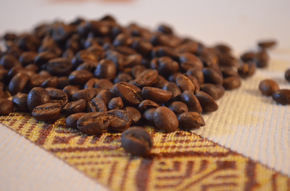 Coffee beans resting on colourful Ethiopian fabric